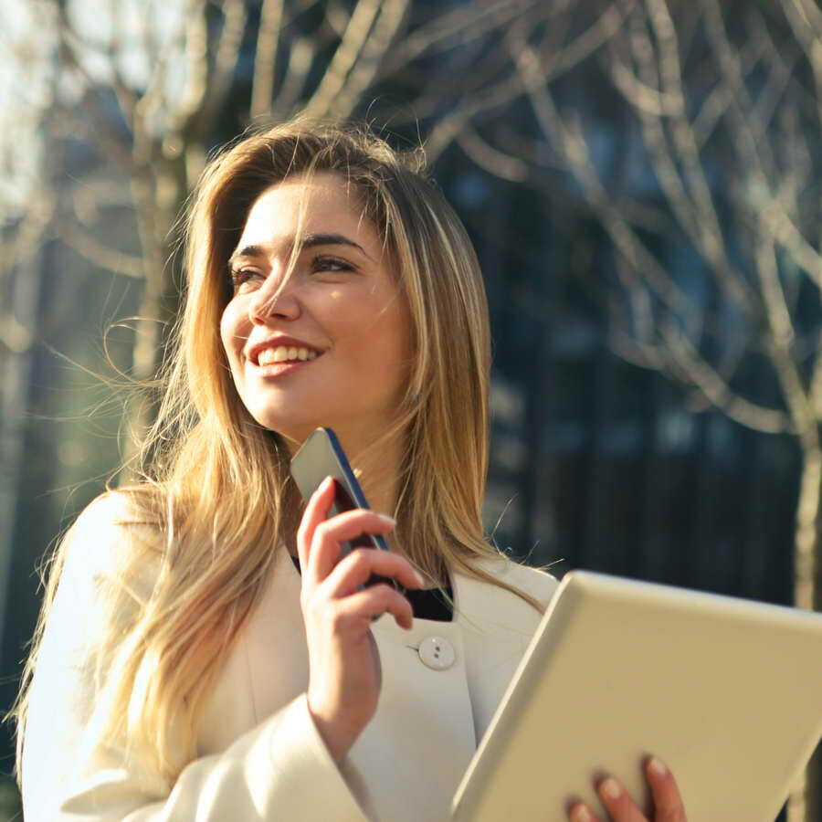 Real estate agent with phone and computer | Real Estate Communications Solutions | VanBelkum